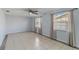 Neutral living room featuring tiled floors, neutral paint, and two windows at 711 Forest Hill Nw Ln, Port Charlotte, FL 33948