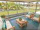 Cozy screened-in patio with comfortable seating and outdoor views, perfect for relaxing at 711 Forest Hill Nw Ln, Port Charlotte, FL 33948
