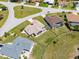 An aerial view captures the home's layout, screened-in lanai, and proximity to a golf course, enhancing its appeal at 7334 N Tulip Tree, Punta Gorda, FL 33955