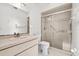 Bright bathroom featuring a standing shower with sliding glass doors and an elongated mirror at 7334 N Tulip Tree, Punta Gorda, FL 33955