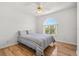 Cozy bedroom featuring light hardwood floors and a large arched window at 7334 N Tulip Tree, Punta Gorda, FL 33955