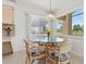 Bright breakfast nook featuring a glass table and wicker chairs with expansive views of the property at 7334 N Tulip Tree, Punta Gorda, FL 33955