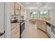 Traditional kitchen with stainless appliances, light-colored cabinets and a breakfast nook with beautiful views at 7334 N Tulip Tree, Punta Gorda, FL 33955