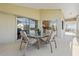 A screened-in patio with a dining set, perfect for outdoor relaxation, offering views of the expansive backyard and golf course at 7334 N Tulip Tree, Punta Gorda, FL 33955