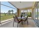 Screened-in patio with outdoor dining set, overlooking the well-kept backyard and golf course, creating a peaceful outdoor space at 7334 N Tulip Tree, Punta Gorda, FL 33955