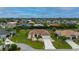 Aerial view of a single story house with a 2 car garage, beautiful lawn and tropical landscaping at 7512 Pon Kan, Punta Gorda, FL 33955