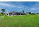 Private backyard features a screened pool enclosure, large grassy area, and mature landscaping at 7512 Pon Kan, Punta Gorda, FL 33955