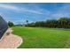 Large backyard with tropical landscaping surrounding the property and a screened lanai with pool at 7512 Pon Kan, Punta Gorda, FL 33955