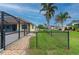 Fenced backyard with a screened lanai and a view of the surrounding neighborhood at 7512 Pon Kan, Punta Gorda, FL 33955