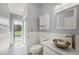 The bathroom has a modern sink, and a door that leads to the pool area at 7512 Pon Kan, Punta Gorda, FL 33955