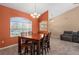 Dining area featuring a modern table set, large window, chandelier, and tiled floors at 7512 Pon Kan, Punta Gorda, FL 33955