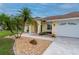 Inviting front entrance with decorative rock landscaping, leading to a charming single-story home at 7512 Pon Kan, Punta Gorda, FL 33955