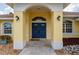 Close up of the front entrance with a double front door and decorative rock landscaping at 7512 Pon Kan, Punta Gorda, FL 33955