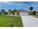 Well-maintained one-story home, featuring a lush front lawn, rock landscaping, and a two-car garage at 7512 Pon Kan, Punta Gorda, FL 33955