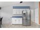 Bright kitchen area featuring a stainless steel refrigerator, white cabinetry, and ample counter space at 7512 Pon Kan, Punta Gorda, FL 33955