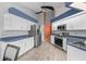 Spacious kitchen featuring white cabinetry, stainless steel appliances, and blue countertops at 7512 Pon Kan, Punta Gorda, FL 33955
