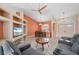 Inviting living room with a gray sectional, custom media center, and plenty of natural light, great for gatherings at 7512 Pon Kan, Punta Gorda, FL 33955
