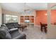 Comfortable living room featuring a large sectional sofa, entertainment center, and access to the lanai at 7512 Pon Kan, Punta Gorda, FL 33955