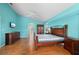 Spacious primary bedroom with wood-look floors, ceiling fan and ensuite bathroom at 7512 Pon Kan, Punta Gorda, FL 33955