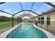 Backyard pool fully screened in with a safety fence and beautiful, clear water at 7512 Pon Kan, Punta Gorda, FL 33955