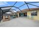 Screened pool area with a -safety fence, a playhouse, and patio furniture for relaxation at 7512 Pon Kan, Punta Gorda, FL 33955