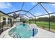 This screened-in pool offers basketball, room for playing, and relaxing at 7512 Pon Kan, Punta Gorda, FL 33955