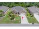 An aerial view of the house with a well maintained lawn and mature landscaping, and a two car driveway at 7652 Mikasa Dr, Punta Gorda, FL 33950