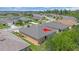 Aerial view of home's backyard featuring a screened lanai, and a well-maintained lawn surrounded by lush landscaping at 7652 Mikasa Dr, Punta Gorda, FL 33950