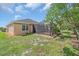 Well-maintained backyard with a screened patio, mature landscaping, and a partially shaded lawn, ideal for relaxation at 7652 Mikasa Dr, Punta Gorda, FL 33950