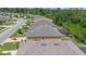 Aerial view of home's backyard showcasing a screened lanai, backyard with grass and landscaping at 7652 Mikasa Dr, Punta Gorda, FL 33950