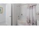 White bathroom with a tub and shower features a shower curtain with a seahorse design at 7652 Mikasa Dr, Punta Gorda, FL 33950