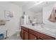 Bright bathroom features a white sink, wood cabinets, and coordinated accessories at 7652 Mikasa Dr, Punta Gorda, FL 33950