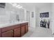 Bathroom with double sinks, dark wood cabinets and tiled flooring at 7652 Mikasa Dr, Punta Gorda, FL 33950