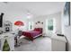 Bright bedroom features neutral walls, white ceiling fan, large windows and wicker furniture at 7652 Mikasa Dr, Punta Gorda, FL 33950