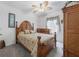 Traditional bedroom featuring a ceiling fan, bed with wood frame, and ample closet space at 7652 Mikasa Dr, Punta Gorda, FL 33950