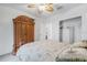 Comfortable bedroom with a ceiling fan, closet, and wood armoire at 7652 Mikasa Dr, Punta Gorda, FL 33950