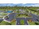 Aerial view of community clubhouse featuring parking area, bocce ball court, and lush landscaping at 7652 Mikasa Dr, Punta Gorda, FL 33950