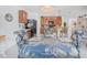 Dining area featuring a glass table, floral chairs and a view of the kitchen at 7652 Mikasa Dr, Punta Gorda, FL 33950