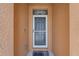 A front door featuring a screen door and covered entry at 7652 Mikasa Dr, Punta Gorda, FL 33950