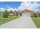 Charming single-story home featuring a well-manicured lawn, covered entry, and attached two-car garage at 7652 Mikasa Dr, Punta Gorda, FL 33950