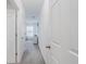 Hallway with white doors, neutral carpet and view of a bedroom at 7652 Mikasa Dr, Punta Gorda, FL 33950