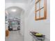 Bright hallway with tile flooring leads to a living area with large windows at 7652 Mikasa Dr, Punta Gorda, FL 33950