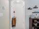 Hallway featuring an arched doorway, decor items, and neutral paint at 7652 Mikasa Dr, Punta Gorda, FL 33950