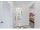 Bright hallway with neutral tile, arched transom and view of the bedroom at 7652 Mikasa Dr, Punta Gorda, FL 33950