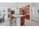 Kitchen with brick backsplash, wood cabinets, and stainless steel appliances and island seating at 7652 Mikasa Dr, Punta Gorda, FL 33950