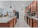 Well-lit kitchen with stainless steel appliances, a central island and wood cabinetry at 7652 Mikasa Dr, Punta Gorda, FL 33950