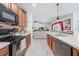 Modern kitchen featuring stainless steel appliances and opening to the living room for easy entertaining at 7652 Mikasa Dr, Punta Gorda, FL 33950