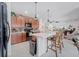 Kitchen featuring wood cabinets, stainless steel appliances, and an open floor plan at 7652 Mikasa Dr, Punta Gorda, FL 33950