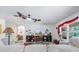 Airy living room features tile floors, ceiling fans, and a TV for relaxation at 7652 Mikasa Dr, Punta Gorda, FL 33950
