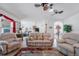 Bright living room with light color furniture, ceiling fan, glass table, and decor with light color walls at 7652 Mikasa Dr, Punta Gorda, FL 33950